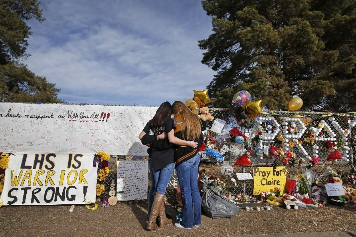 Teens mourn at a memorial after a school shooting in Colorado earlier this month. Exposure therapy may help teens recover from post-traumatic stress disorder, a University of Pennsylvania study suggests.