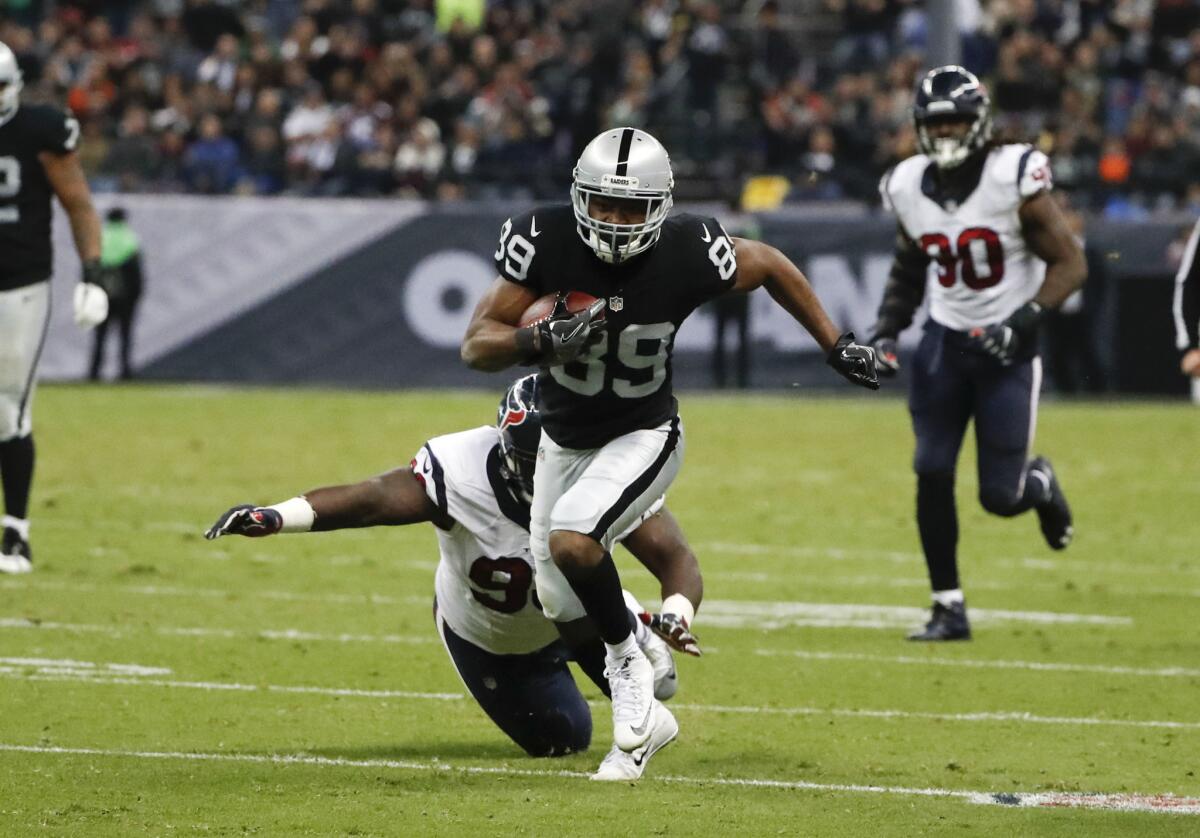 Raiders wide receiver Amari Cooper breaks away from Texans defensive end D.J. Reader on his way to scoring a touchdown during the second half on Nov. 21 in Mexico City.