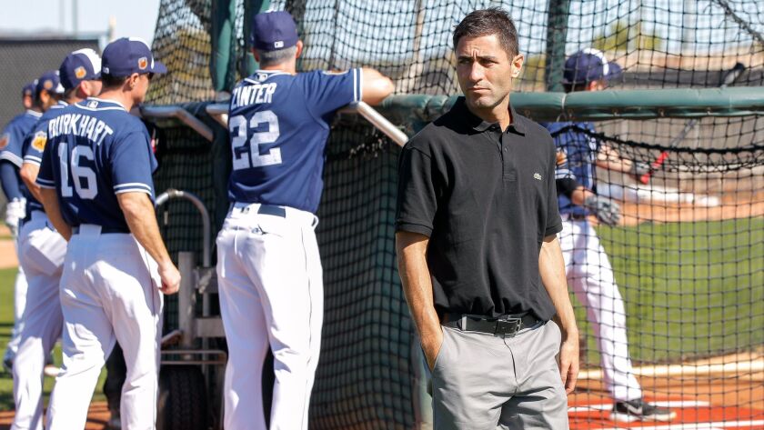 Padres general manager A. J. Preller walks past the cage in spring training.