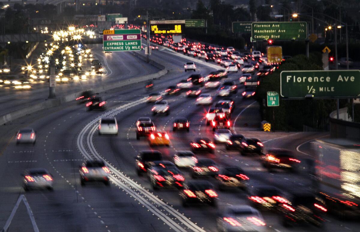 Traffic on the 110 Freeway southbound from Slauson Avenue during rush hour. The toll lanes on the left are relatively clear; other lanes are not.