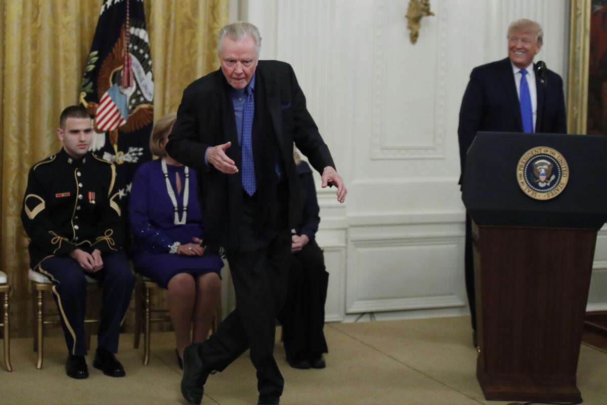 Jon Voight dances as President Donald Trump looks on