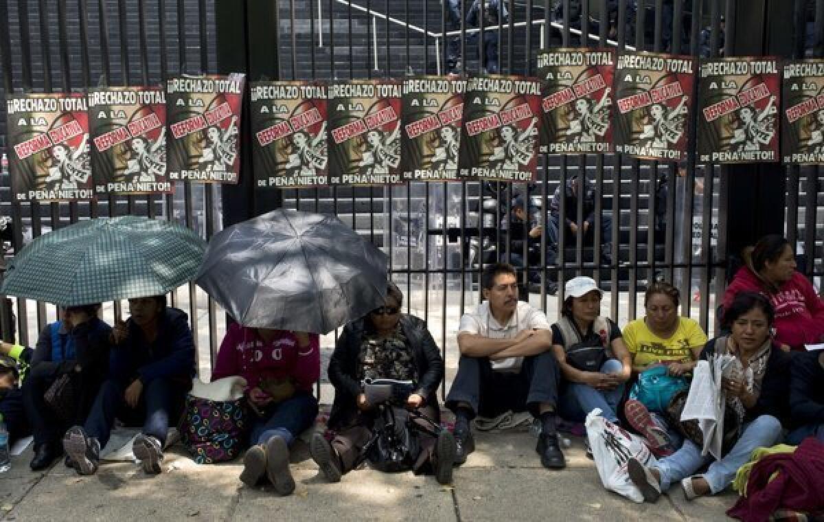 Teachers block access to the Mexican Senate in Mexico City on Thursday to protest education reform legislation.