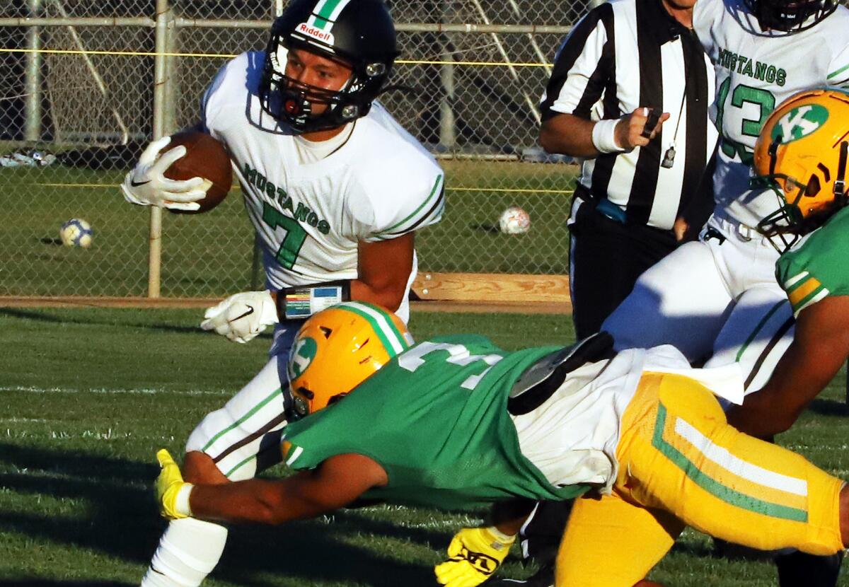 Costa Mesa's Diego Ramirez (7) carries the ball against Kennedy in the season opener at Western High on Thursday.