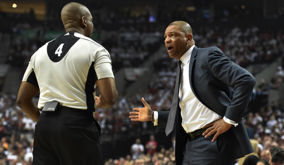Clippers Coach Doc Rivers discusses a call with referee Sean Wright during the first half of Game 6 in Portland.