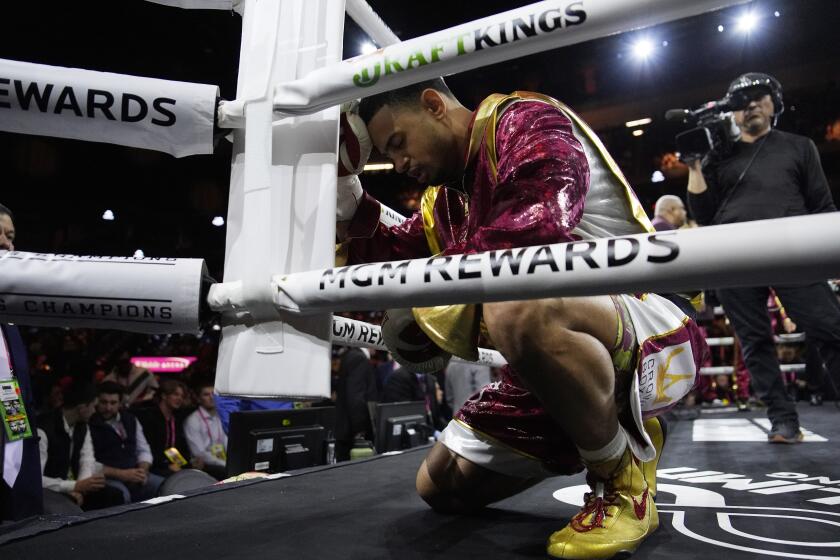 Rolando Romero prays before fighting Isaac Cruz, of Mexico, in a super lightweight title bout Saturday, March 30, 2024, in Las Vegas. (AP Photo/John Locher)