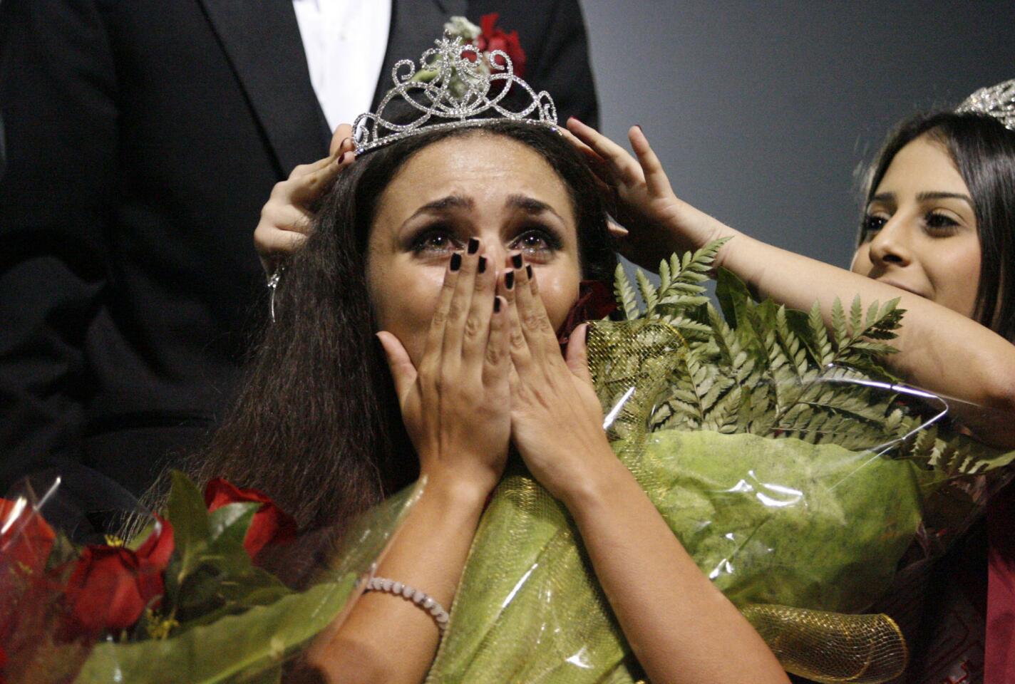 Glendale's Preni Gharibian, right, crowns Arsineh Sarkisian as the homecoming queen during halftime at Glendale High School on Friday, November 2, 2012.