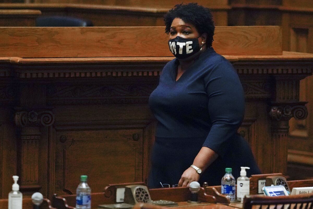 Democrat Stacey Abrams walks on the Georgia Senate floor Dec. 14 in Atlanta.