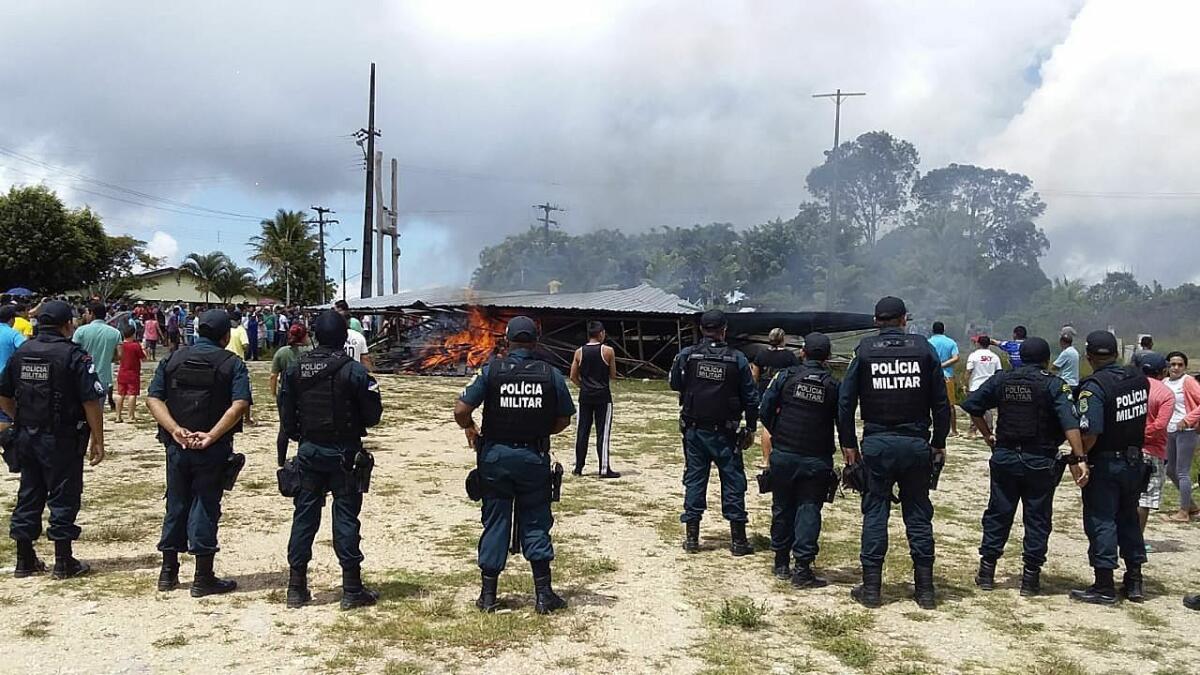 Police try to maintain control as Brazilian people demonstrate Aug. 18 against the presence of Venezuelan immigrants in Pacaraima, Brazil.