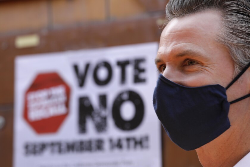 Gavin Newsom wears a mask at a campaign event.