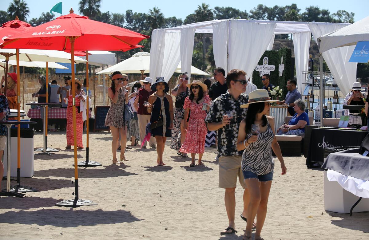Guests walk through the sand.