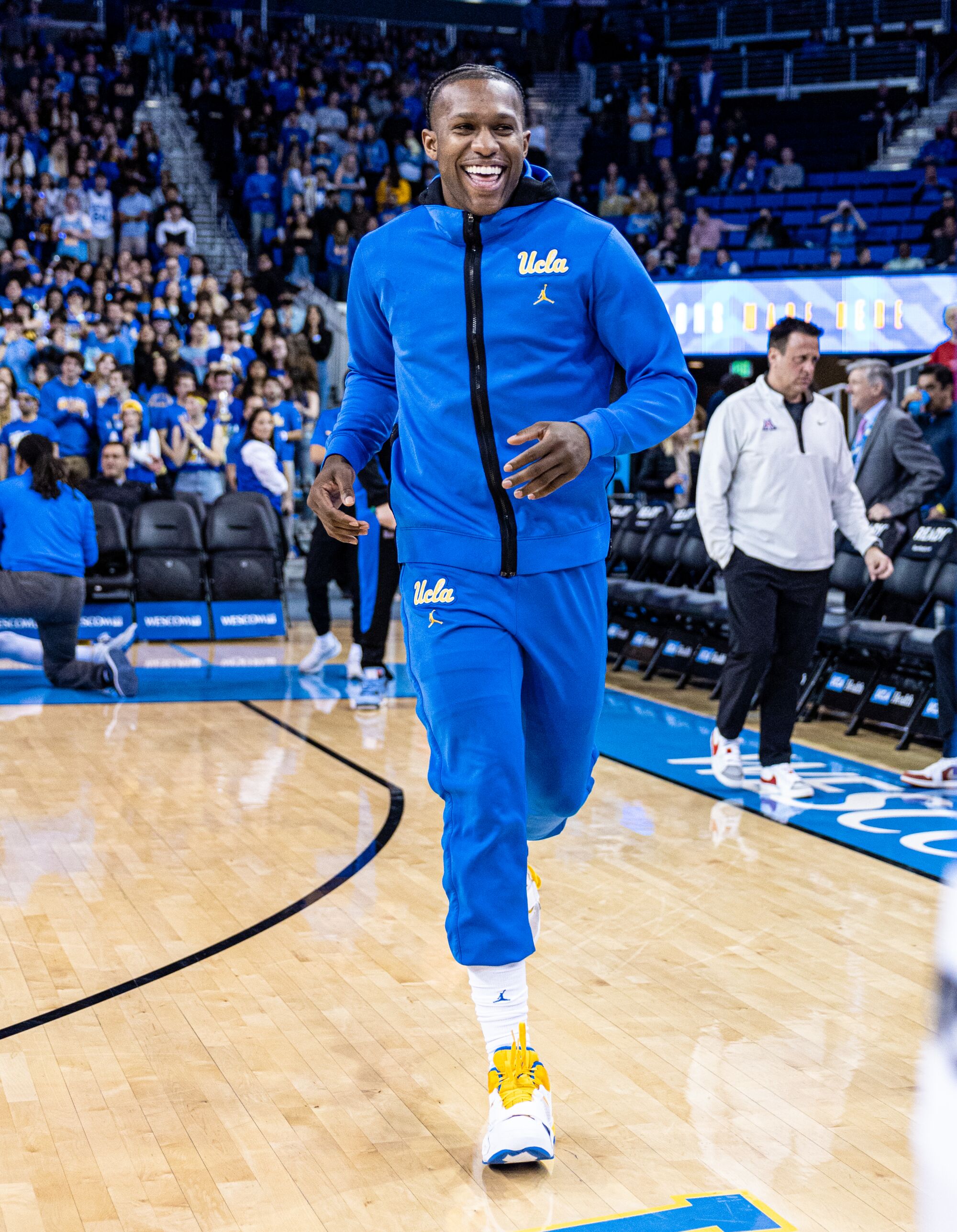 UCLA senior David Singleton smiles as he jogs onto court before the Bruins' game against Arizona
