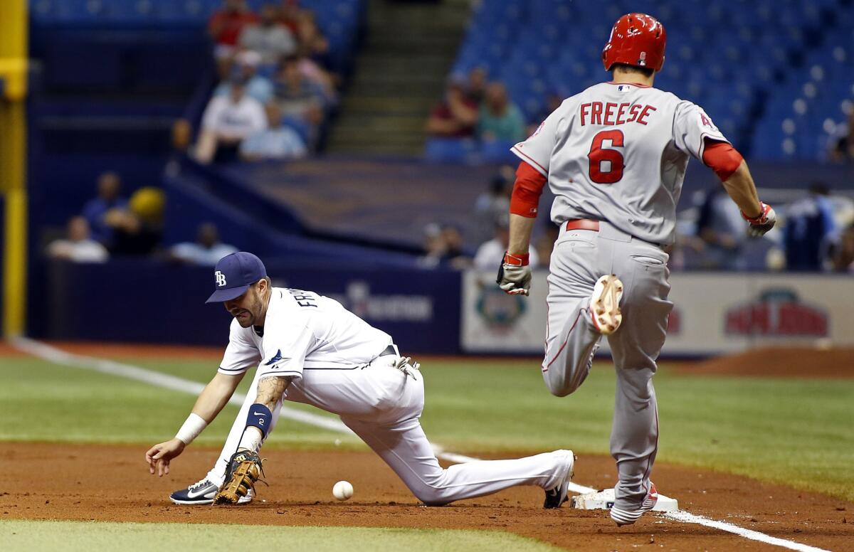 Angels third baseman David Freese hustles down the line to reach on an error when Nick Franklin can't make the play at first base.