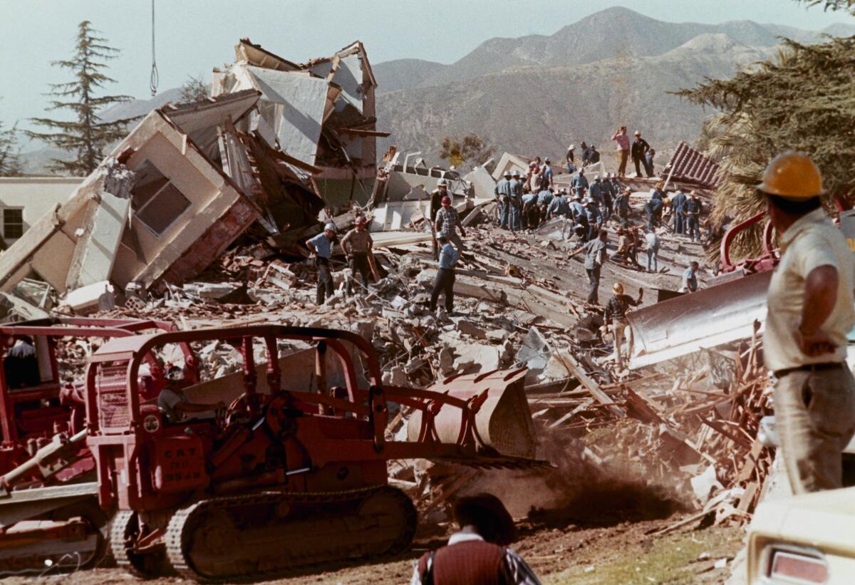 Crews clear debris and rubble from collapsed buildings