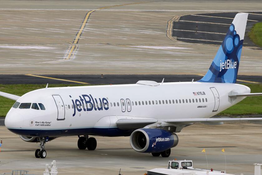 A JetBlue Airways Airbus A320-232 pushes back from the gate at Tampa International Airport.