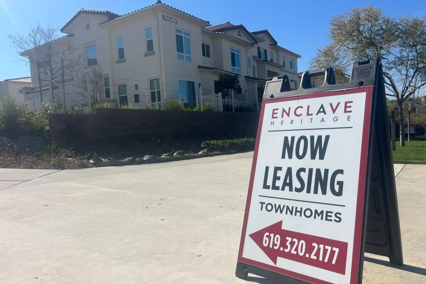 A now leasing sign outside the Enclave Heritage Flats apartment complex