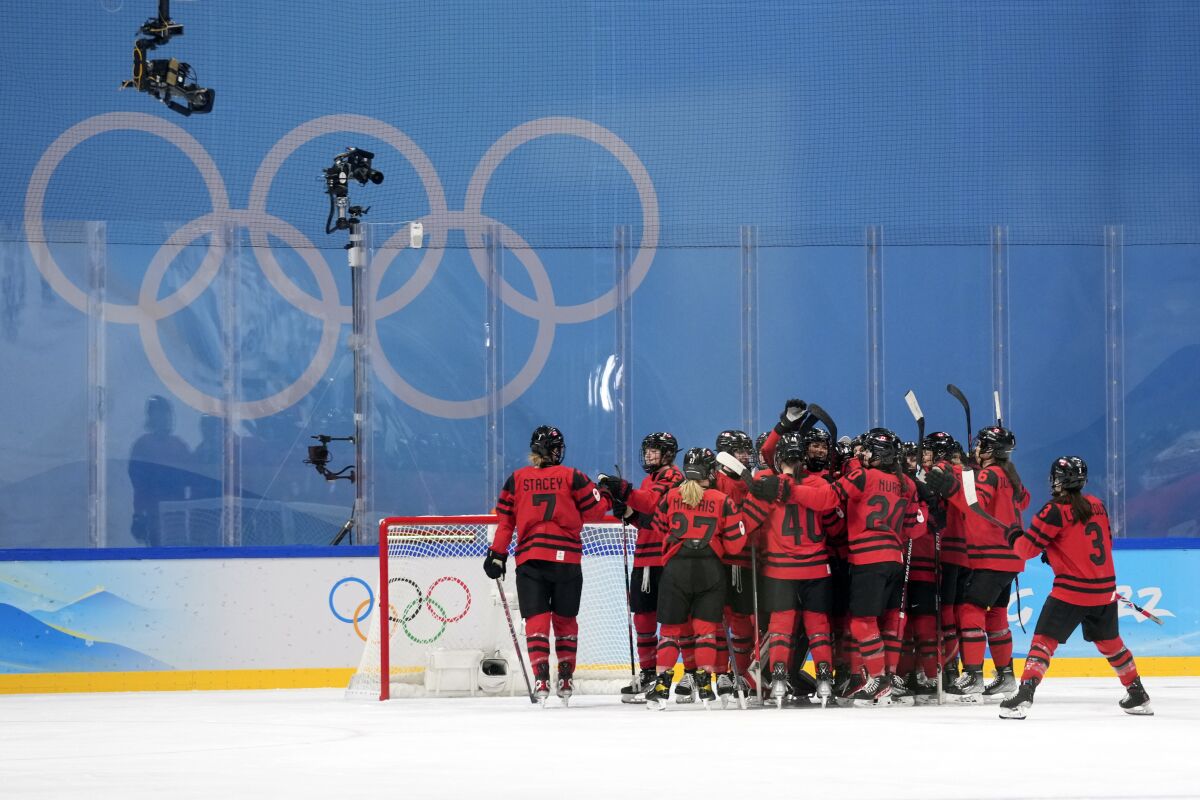 Canada players celebrate after an 11-1 win over Finland in a preliminary round women's hockey game at the 2022 Winter Olympics, Saturday, Feb. 5, 2022, in Beijing. (AP Photo/Petr David Josek)