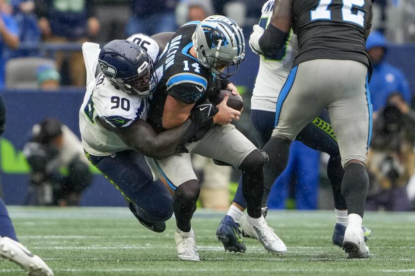 Carolina Panthers quarterback Andy Dalton is sacked by Seattle Seahawks defensive tackle Jarran Reed during the second half of an NFL football game Sunday, Sept. 24, 2023, in Seattle. (AP Photo/Lindsey Wasson)