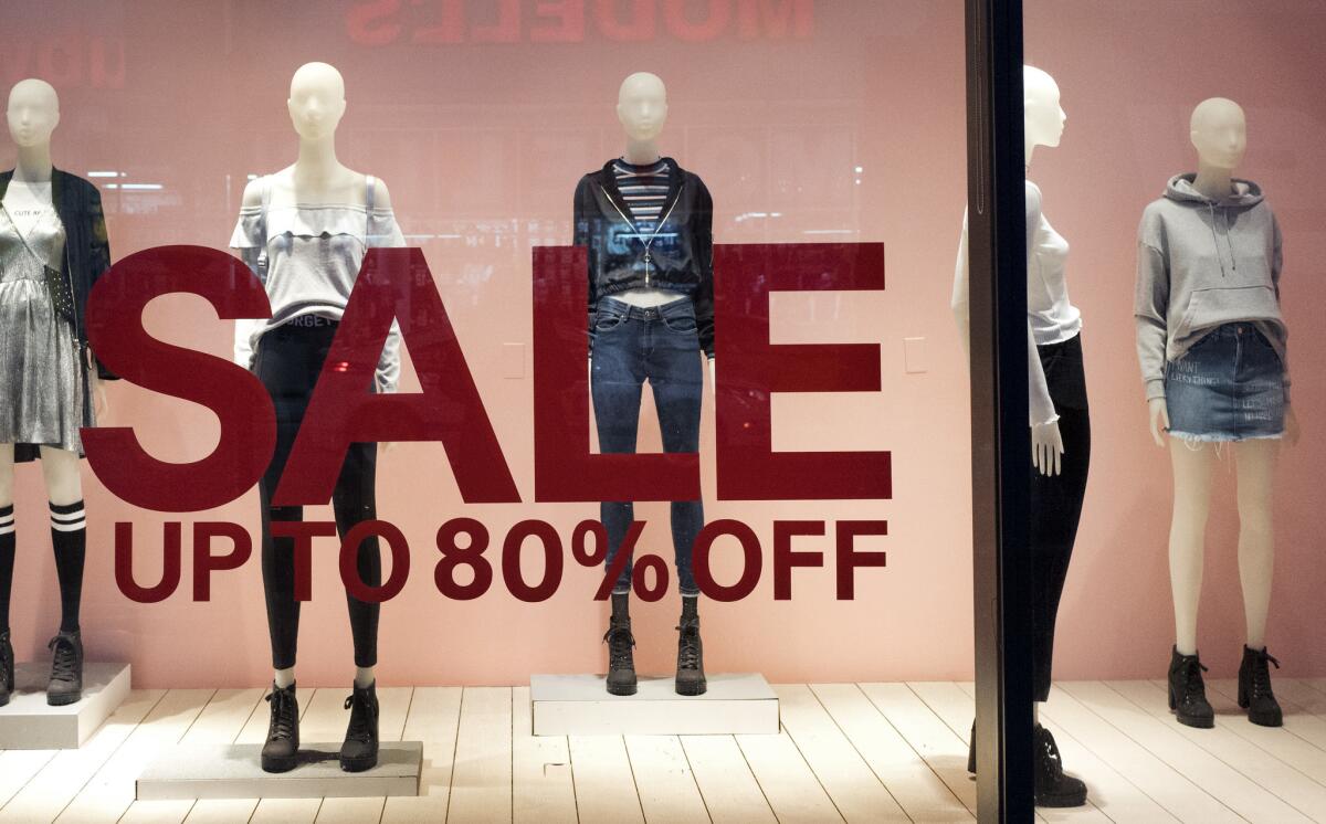 An H&M store window advertises a sale Wednesday in New York. On Friday, the Commerce Department releases U.S. retail sales data for December.