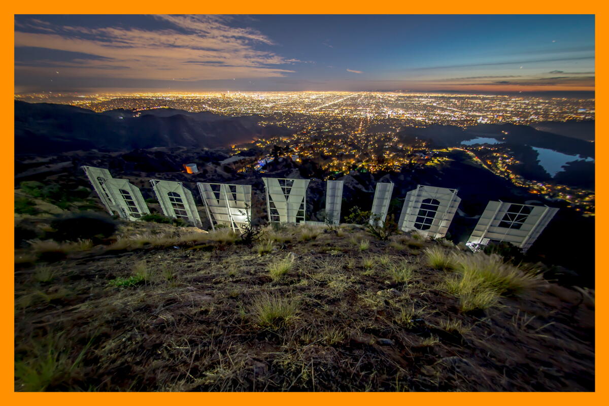 An aerial view of Los Angeles with the back of the Hollywood sign in the foreground