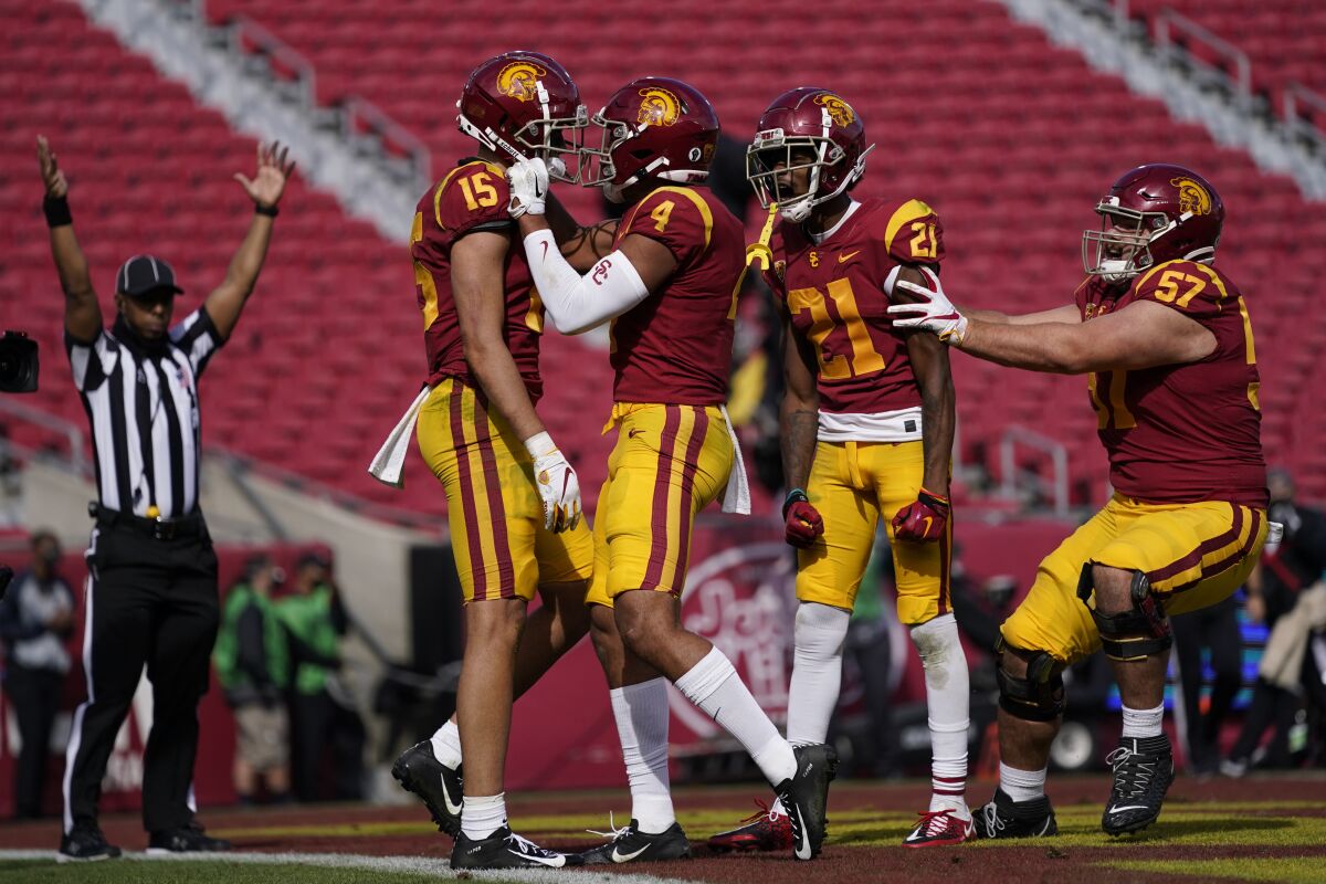 USC wide receiver Drake London celebrates with teammates after catching a pass in the end zone for a touchdown.