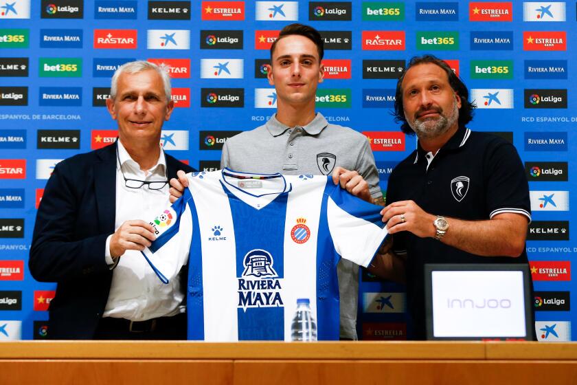 Defender Fernando Calero is flanked by Espanyol vice president Carlos Garcia Pont, left, and sports director Francisco Rufete during his introductory news conference on Aug 9, 2019.