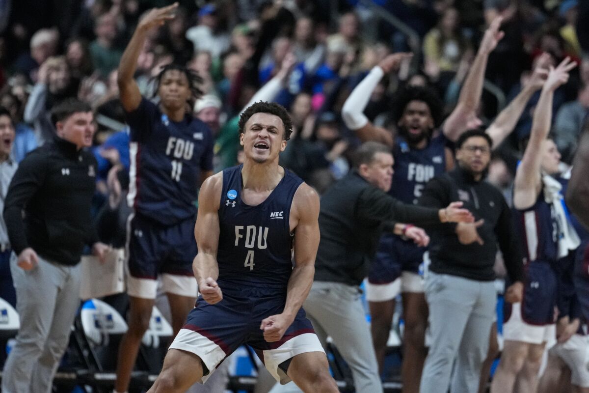 Fairleigh Dickinson guard Grant Singleton (4) celebrates after a basket against Purdue on March 17, 2023.