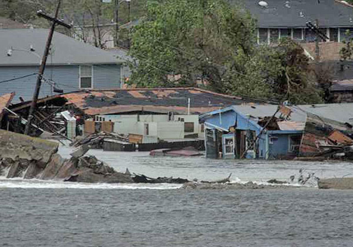 Water pours over a recently repaired levee of the Inner Harbor Navigational Canal, causing flooding in the 9th Ward of New Orleans.