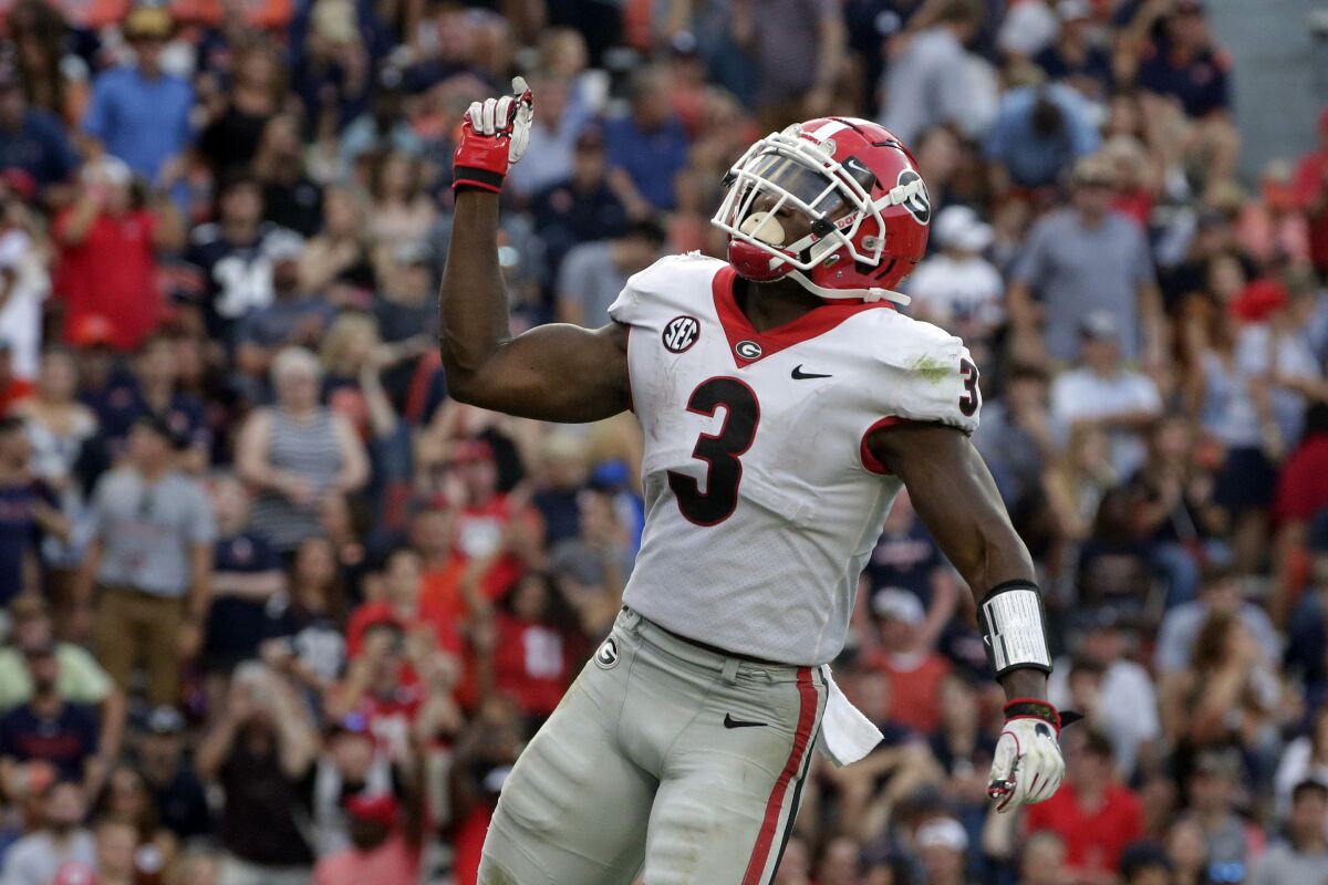 Georgia running back Zamir White (3) celebrates after a touchdown against Auburn during the second half of an NCAA college football game Saturday, Oct. 9, 2021, in Auburn, Ala. (AP Photo/Butch Dill)