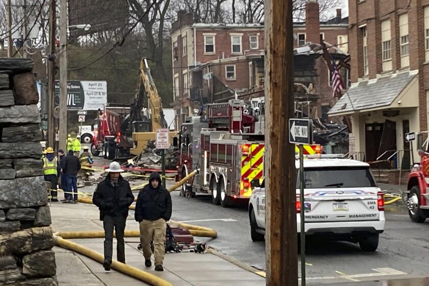 Emergency personnel and heavy equipment work at the site of a deadly explosion at a chocolate factory in West Reading, Pa.,, Saturday, March 25, 2023. (AP Photo/Michael Rubinkam)