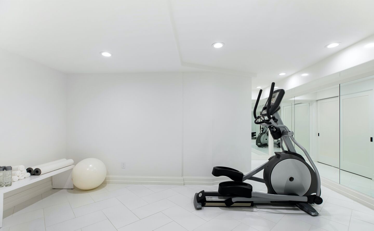 White walled gym and exercise equipment.