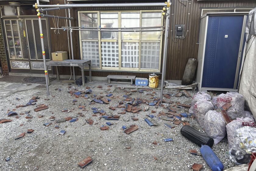 Tiles are scattered after an earthquake in Kisarazu, Chiba prefecture, near Tokyo Thursday, May 11, 2023. An earthquake shook Japan's capital, Tokyo, and surrounding areas on Thursday, injuring several people and causing minor damage, officials and media said. (Kyodo News via AP)