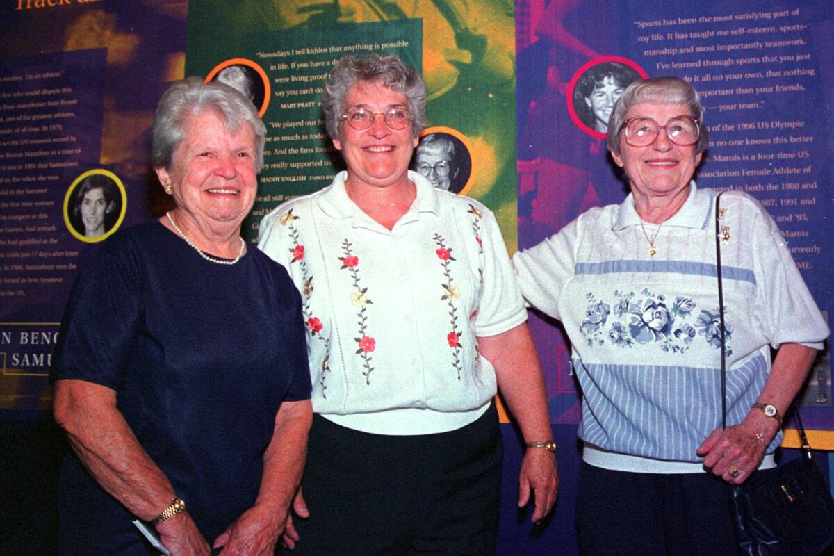 Former women's pro baseball players Mary Pratt, left, and Maddy English, right, are joined by friend Marie Cronin in 1999.
