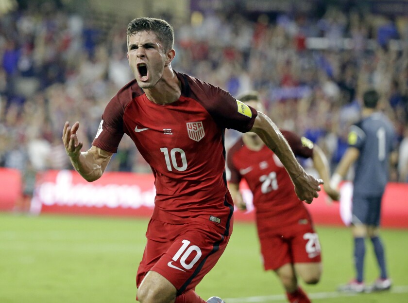 FILE - United States' Christian Pulisic (10) celebrates after scoring a goal against  