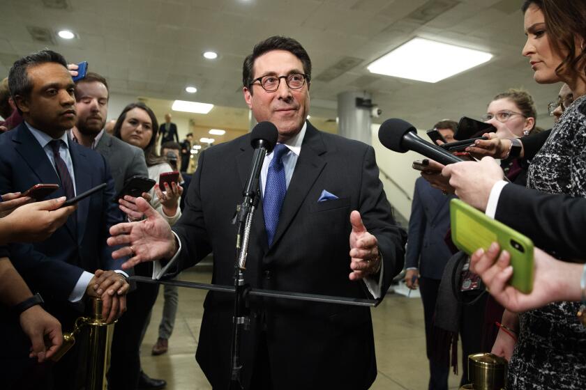 President Donald Trump's personal attorney Jay Sekulow, center, speaks to the media during a break in the impeachment trial of President Donald Trump, Wednesday, Jan. 22, 2020, on Capitol Hill in Washington. (AP Photo/ Jacquelyn Martin)