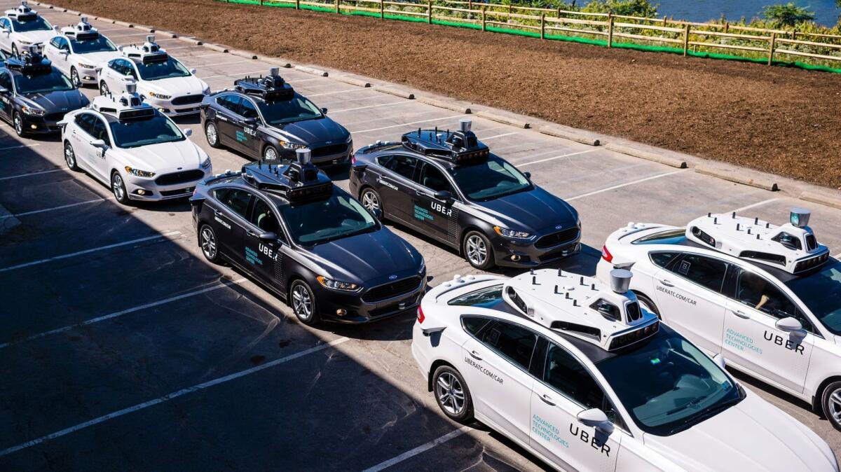 Pilot models of an Uber self-driving car are displayed in 2016 in Pittsburgh.