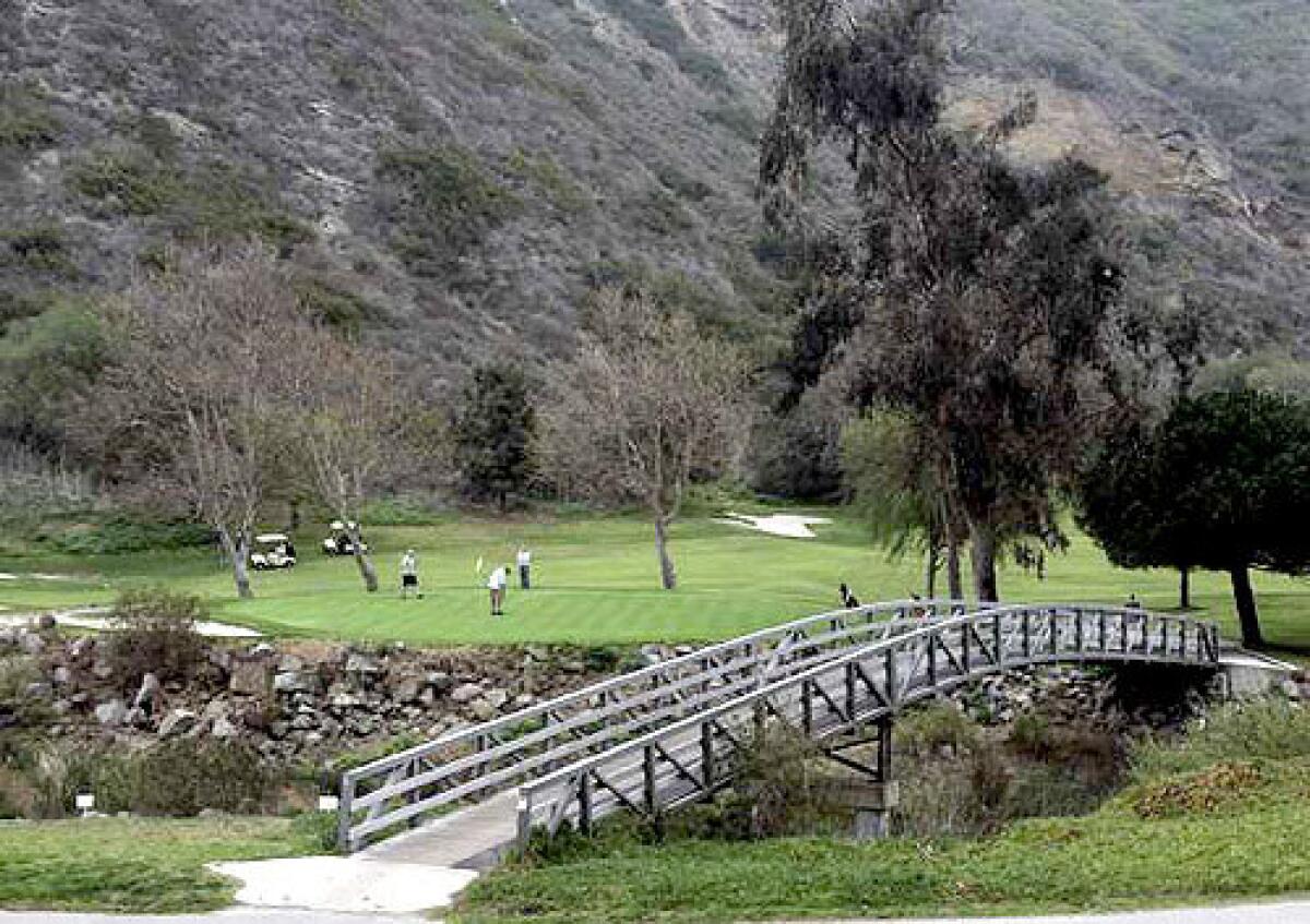 Golfers line up their puts at the ninth hole at Aliso Creek Golf Course in Laguna Beach.