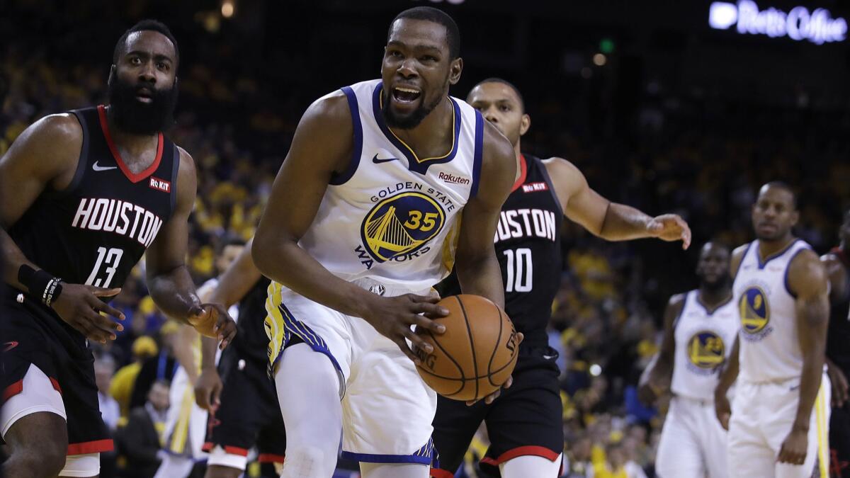 Houston Rockets' James Harden, left, and Golden State Warriors' Kevin Durant (35) react to a referee's call during the second half of Game 5 of a second-round NBA playoff series on Wednesday in Oakland.