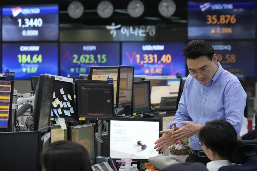 Currency traders work at the foreign exchange dealing room of the KEB Hana Bank headquarters in Seoul, South Korea, Wednesday, Feb. 28, 2024. Asian markets were mostly lower on Wednesday after U.S. stocks held near their record levels in a quiet day of trading.(AP Photo/Ahn Young-joon)