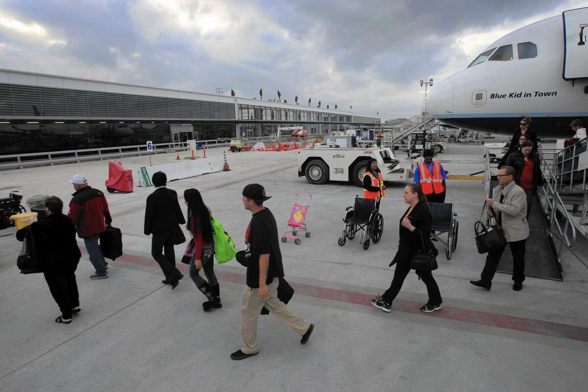 JetBlue Airways passengers from Las Vegas arrive at the airline's passenger concourse at Long Beach Airport in 2012. JetBlue is the biggest carrier at Long Beach with more than 80% of the daily flights.