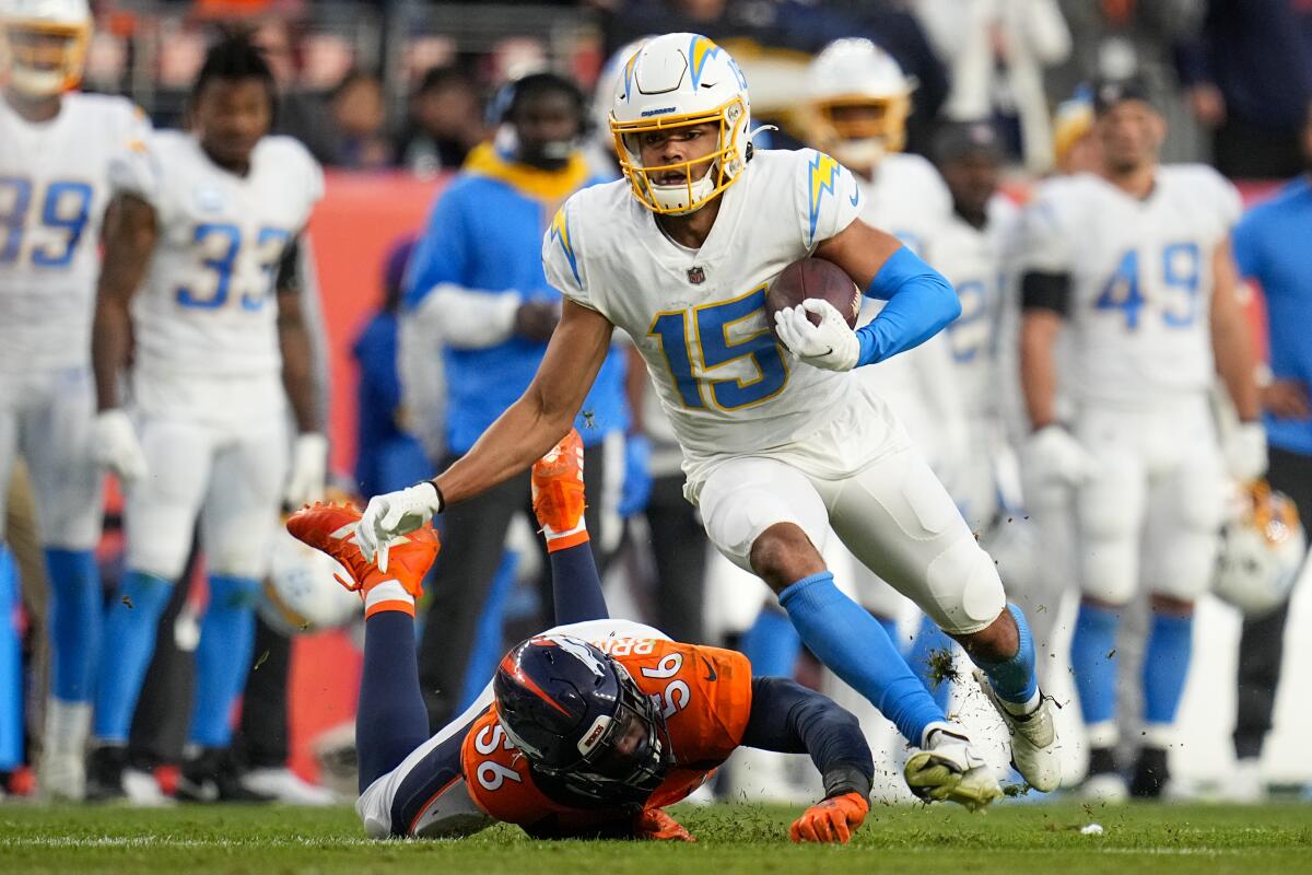 Chargers wide receiver Jalen Guyton runs with the ball in front of Denver Broncos inside linebacker Baron Browning.