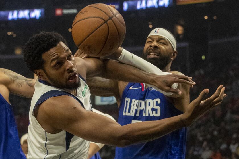 LOS ANGELES, CA - November 23 2021: LA Clippers forward Marcus Morris Sr. (8) , right, battles Dallas Mavericks forward Sterling Brown (0) for a rebound in second quarter at Staples Center on Tuesday, Nov. 23, 2021 in Los Angeles, CA. (Brian van der Brug / Los Angeles Times