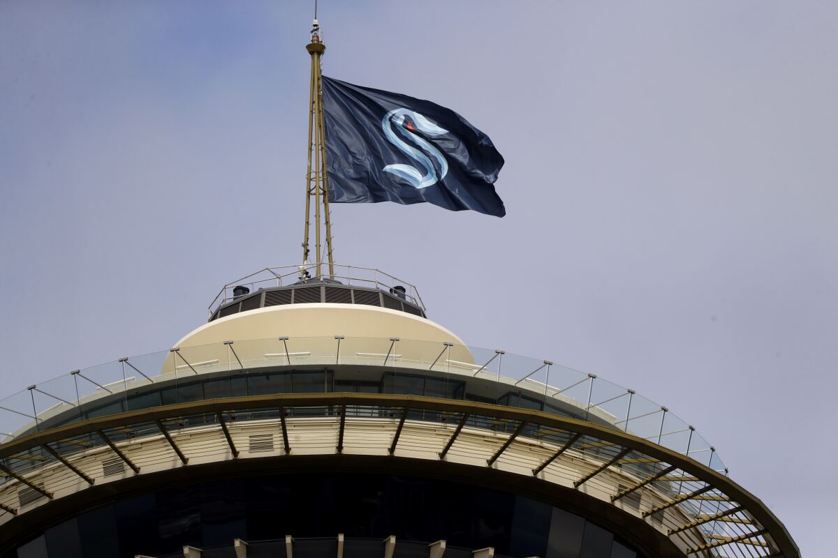 A flag with the logo of the Seattle Kraken flies atop the iconic Space Needle on July 23.