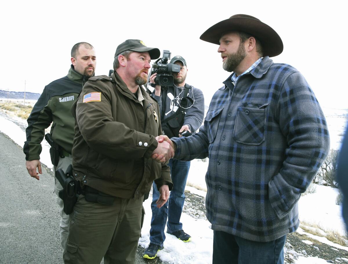 Harney County Sheriff Dave Ward meets Ammon Bundy in January outside the Malheur National Wildlife Refuge in Oregon.