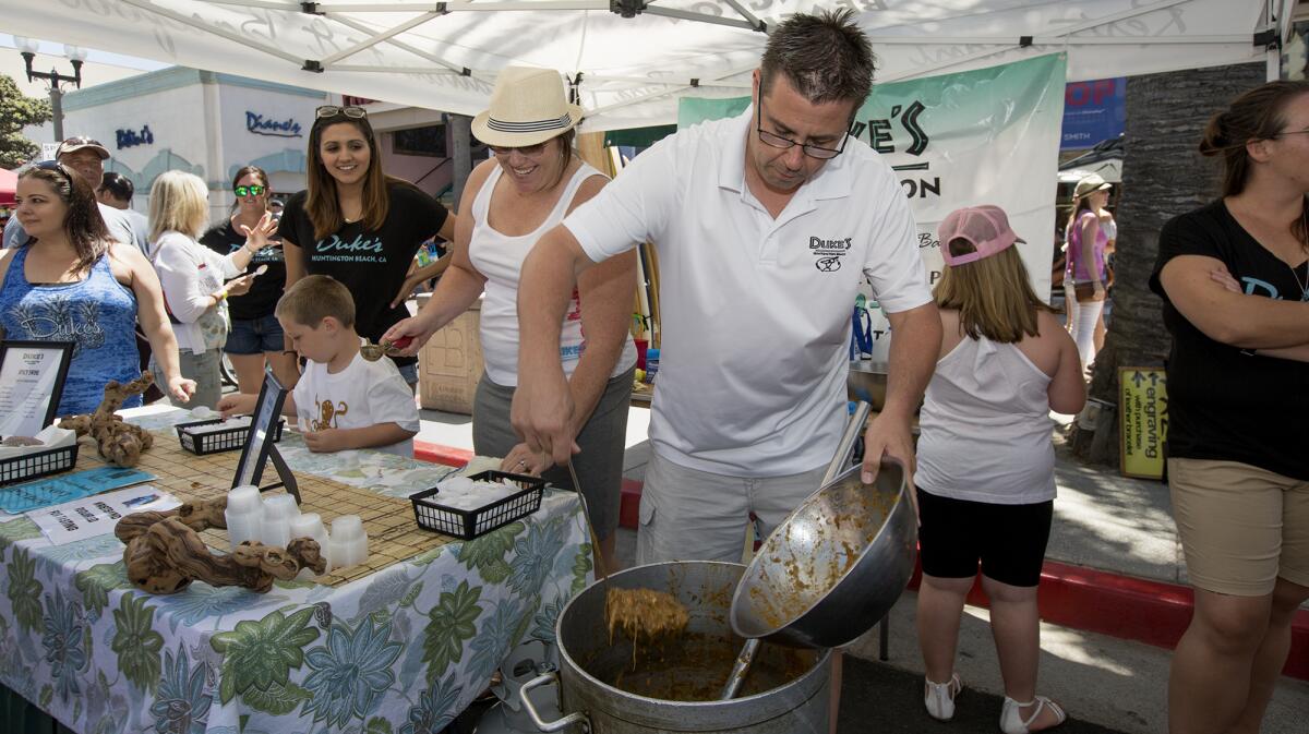 Ryan Clancy refills a bowl with wild boars head chili during the 2017 Chili at the Beach competition.