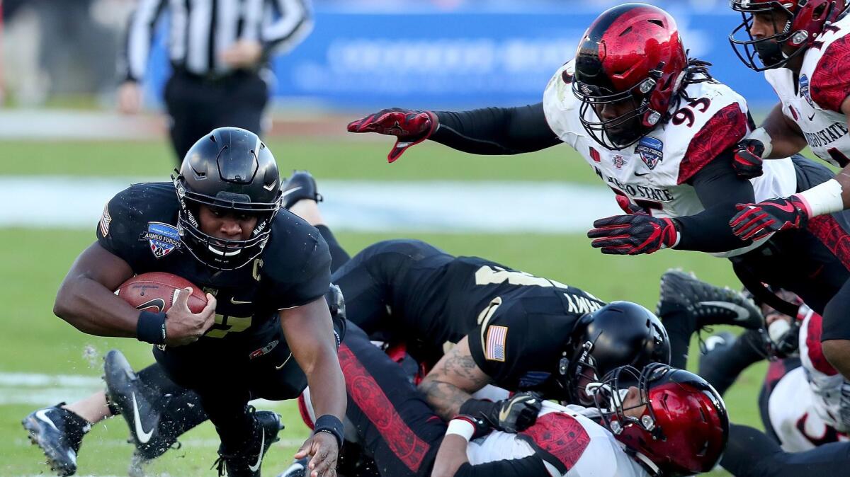 Ahmad Bradshaw of the Army Black Knights carries the ball against Noble Hall of the San Diego State Aztecs in the first half of the Armed Forces Bowl at Amon G. Carter Stadium.