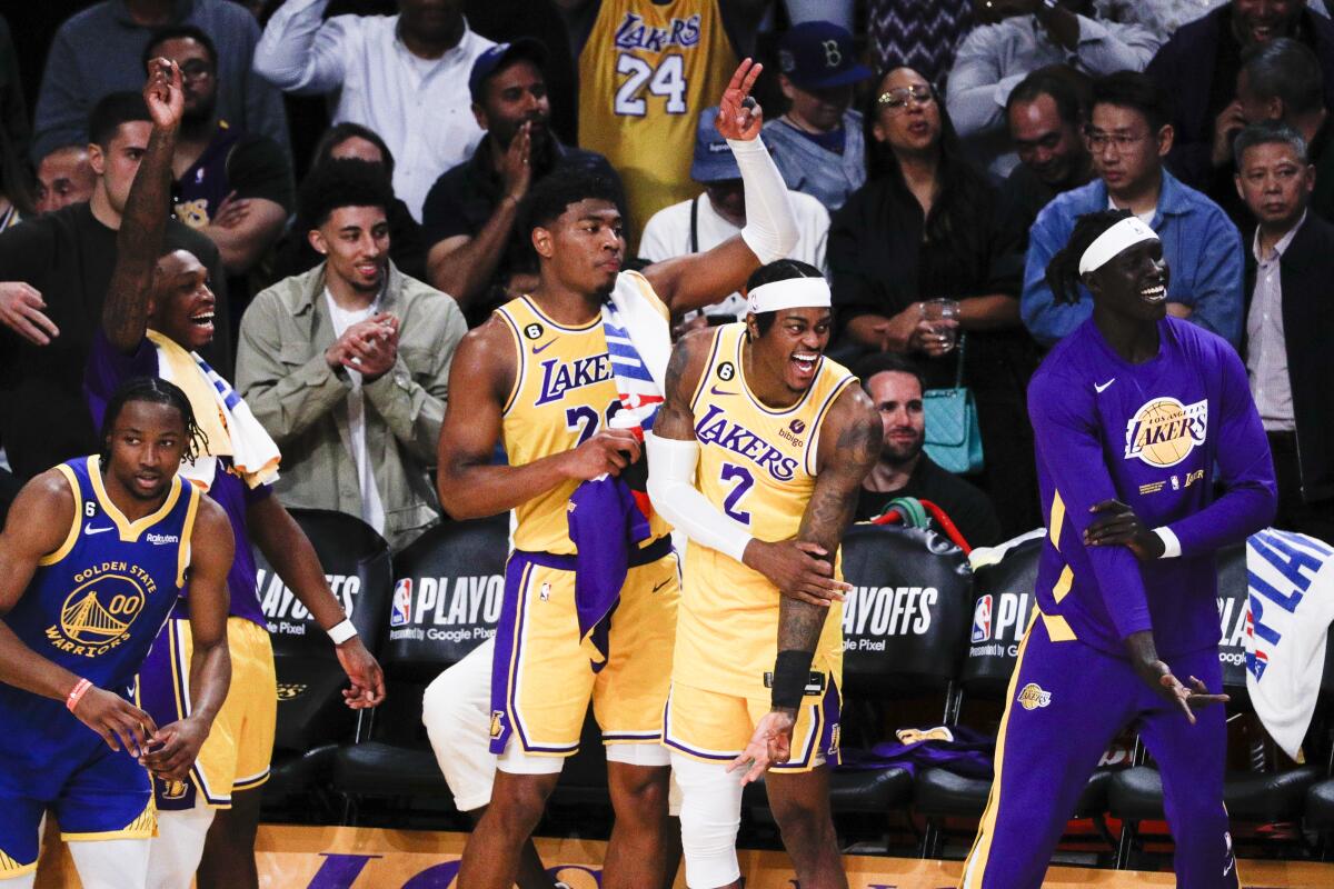 Forwards Rui Hachimura, left, and Jarred Vanderbilt celebrate on the Lakers bench during their Game 6 win over the Warriors.