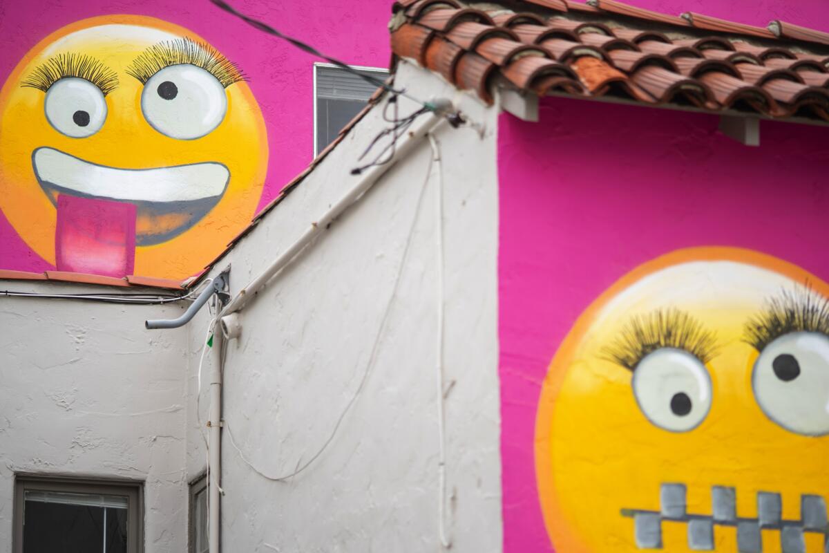 Some neighbors think the painted emojis on the Manhattan Beach house are meant to mock them.