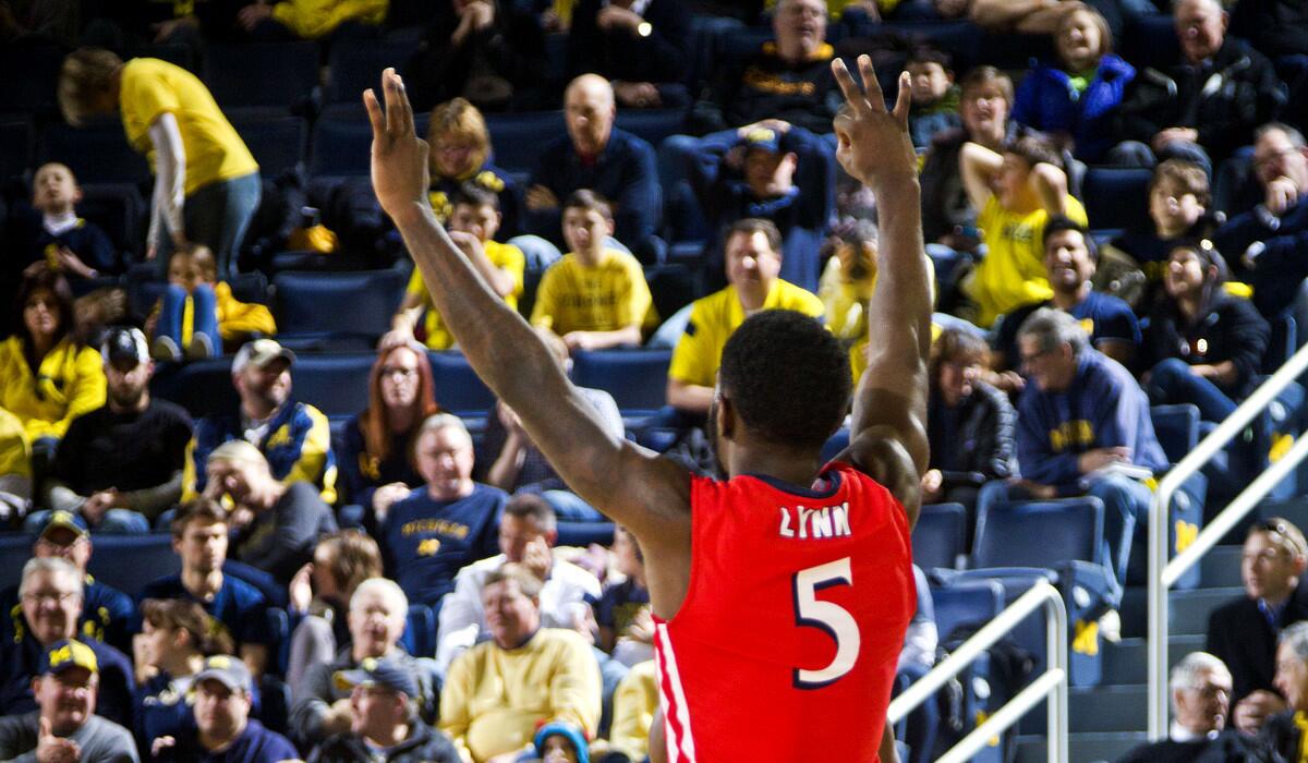 NJIT guard Damon Lynn celebrates after making a three-pointer during a 72-70 upset of No. 17-ranked Michigan on Saturday.