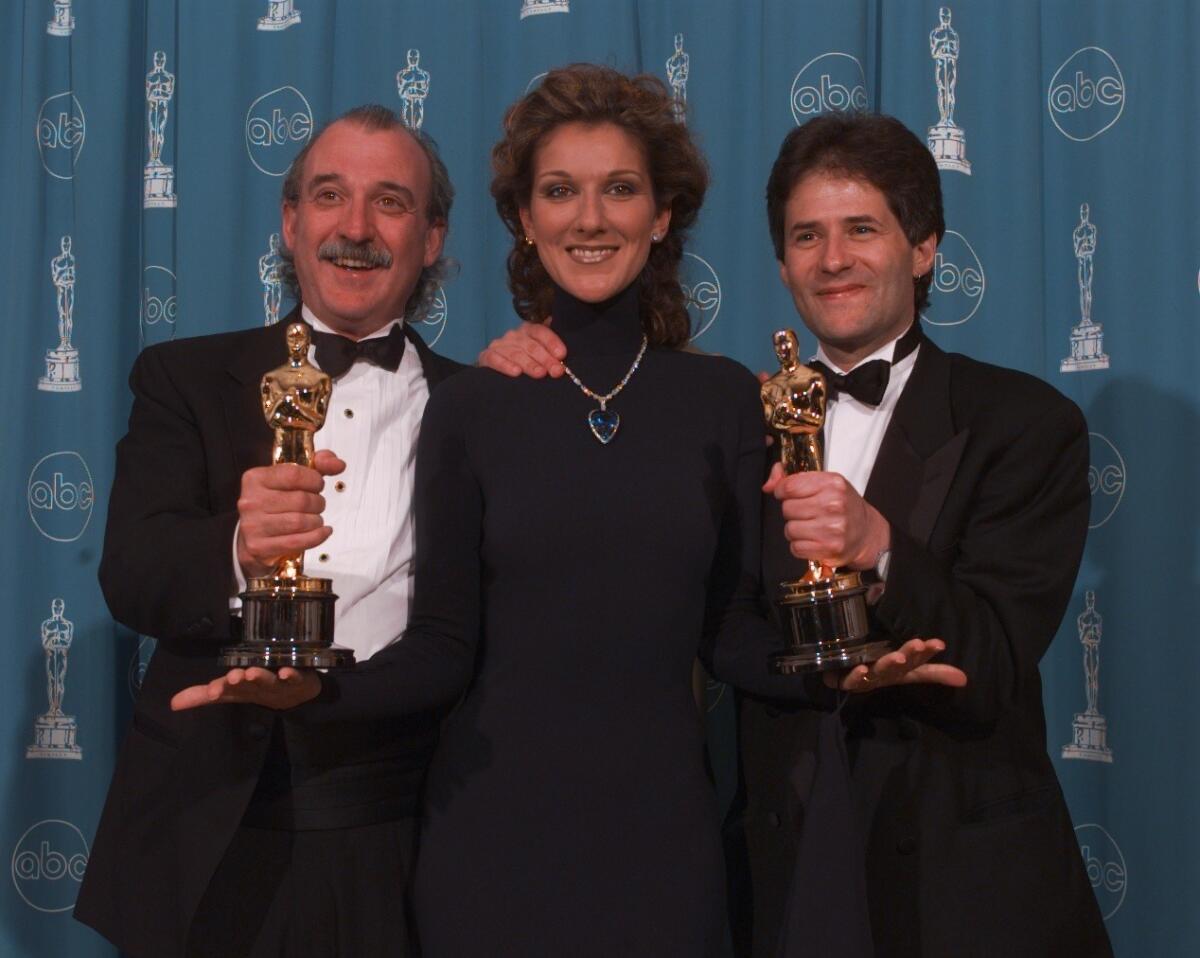 Will Jennings, left, Celine Dion and James Horner at the 70th Academy Awards at the Shrine Auditorium in Los Angeles in 1998.