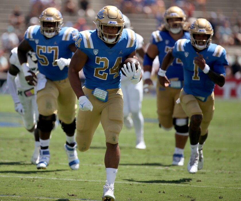 UCLA running back Zach Charbonnet breaks free for a touchdown run against Hawaii in the first quarter Aug. 28, 2021.